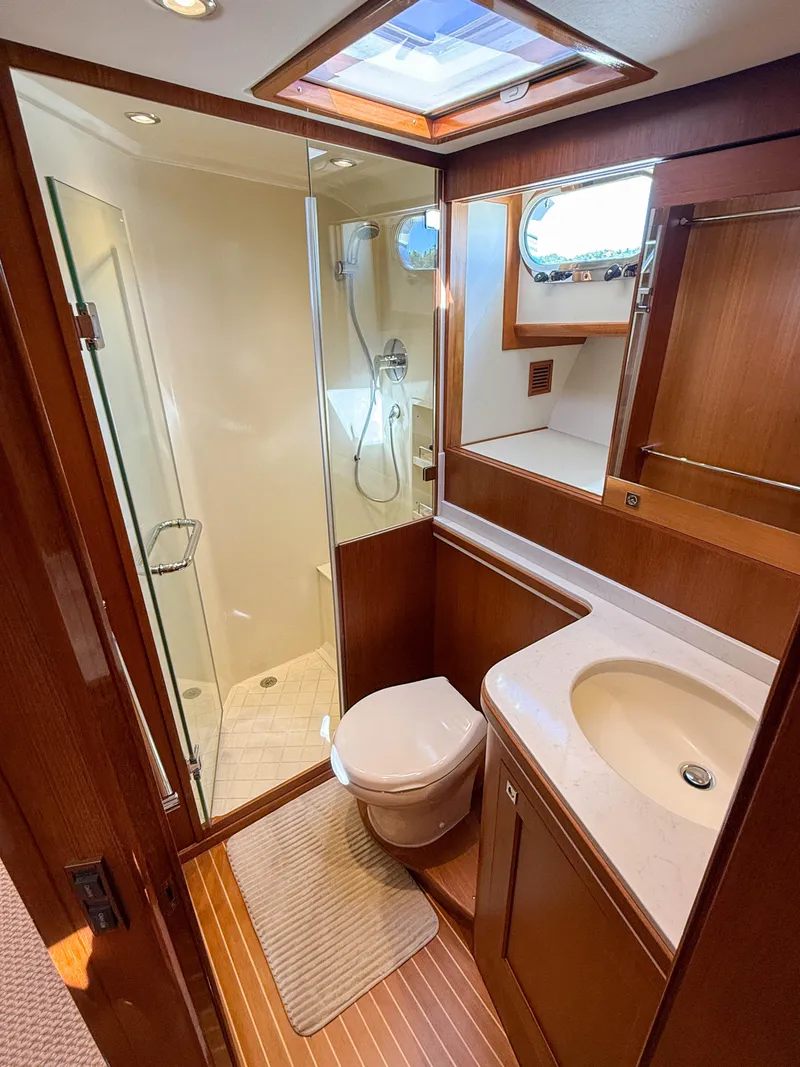 Slide: The Image of Luxurious 2014 Grand Banks 50 Eastbay SX yacht bathroom with wood accents and modern fixtures. - 31
