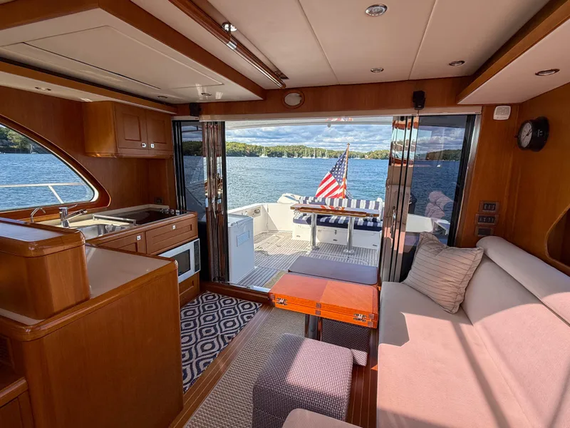 Slide: The Image of Luxurious 2014 Grand Banks 50 Eastbay SX yacht interior with lake view and American flag. - 34