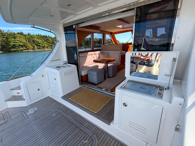Slide: The Image of 2014 Grand Banks 50 Eastbay SX yacht interior with seating and scenic water view. - 36