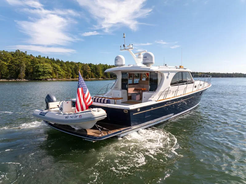 Slide: The Image of 2014 Grand Banks 50 Eastbay SX yacht cruising on a scenic lake. - 4