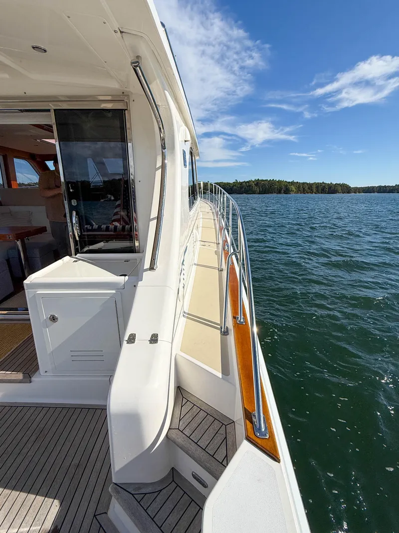 Slide: The Image of 2014 Grand Banks 50 Eastbay SX yacht on open water, sunny day, sleek design. - 41