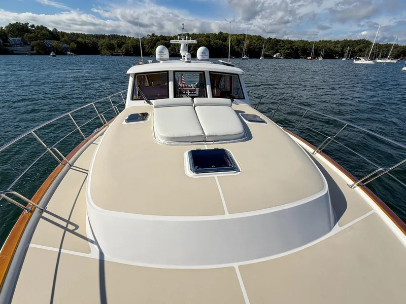 Slide: The Image of 2014 Grand Banks 50 Eastbay SX yacht on calm water, showcasing spacious deck and sleek design. - 45