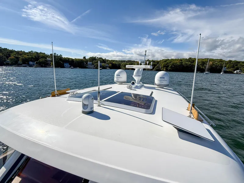 Slide: The Image of 2014 Grand Banks 50 Eastbay SX yacht on serene water under blue sky. - 46