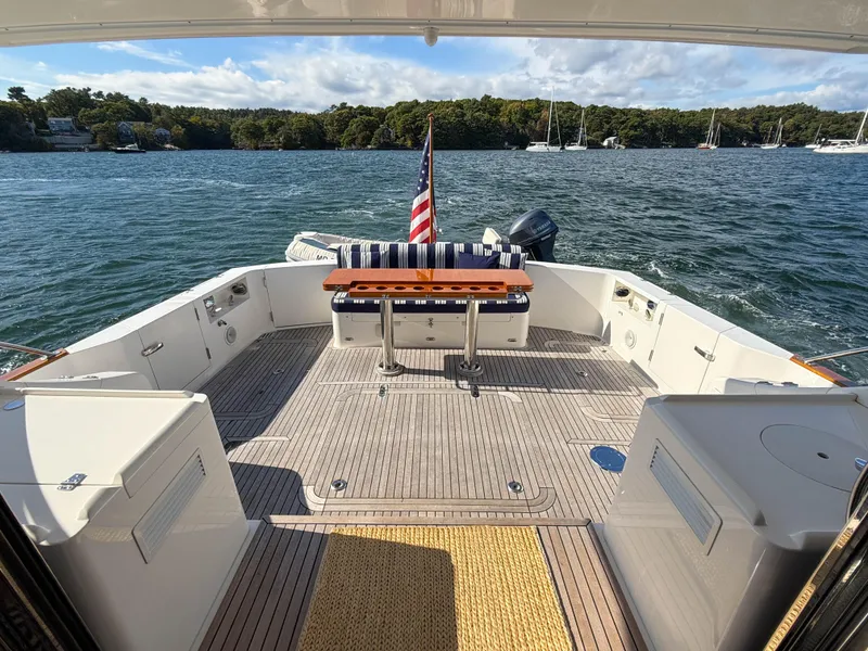 Slide: The Image of 2014 Grand Banks 50 Eastbay SX yacht deck with seating, table, and ocean view. - 5