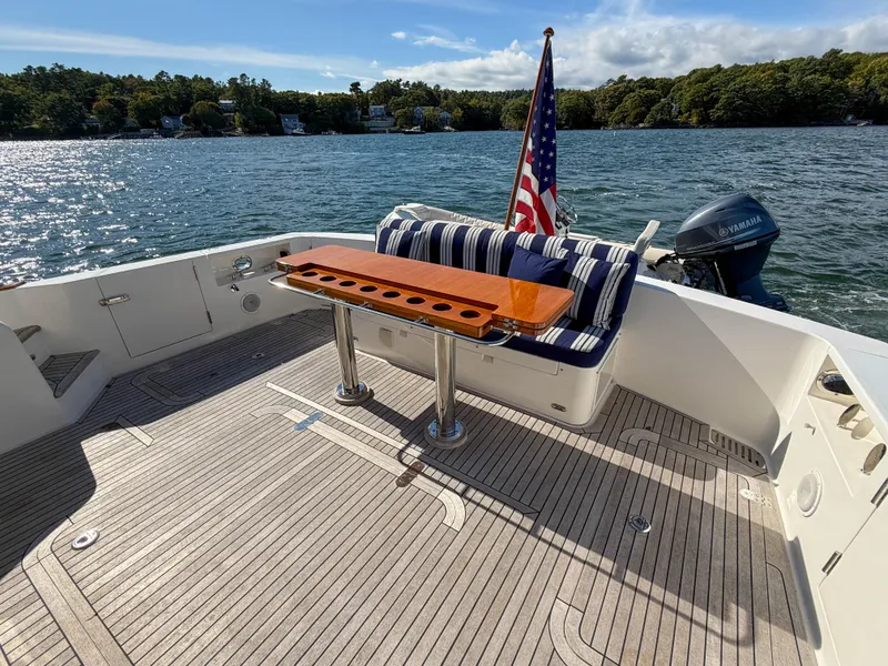 Slide: The Image of 2014 Grand Banks 50 Eastbay SX yacht deck with seating and American flag. - 6