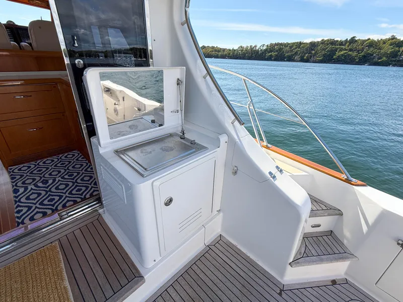 Slide: The Image of 2014 Grand Banks 50 Eastbay SX yacht deck with outdoor sink and scenic water view. - 8