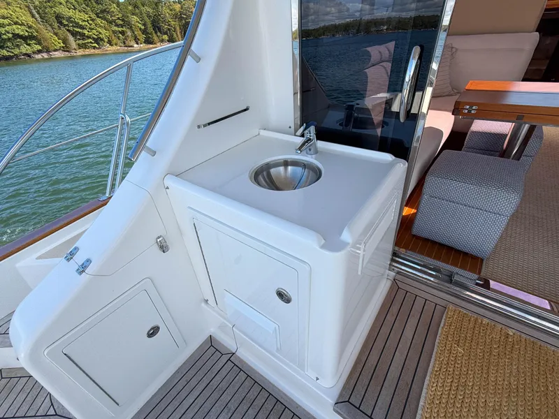 Slide: The Image of 2014 Grand Banks 50 Eastbay SX yacht interior with sink and seating area. - 9