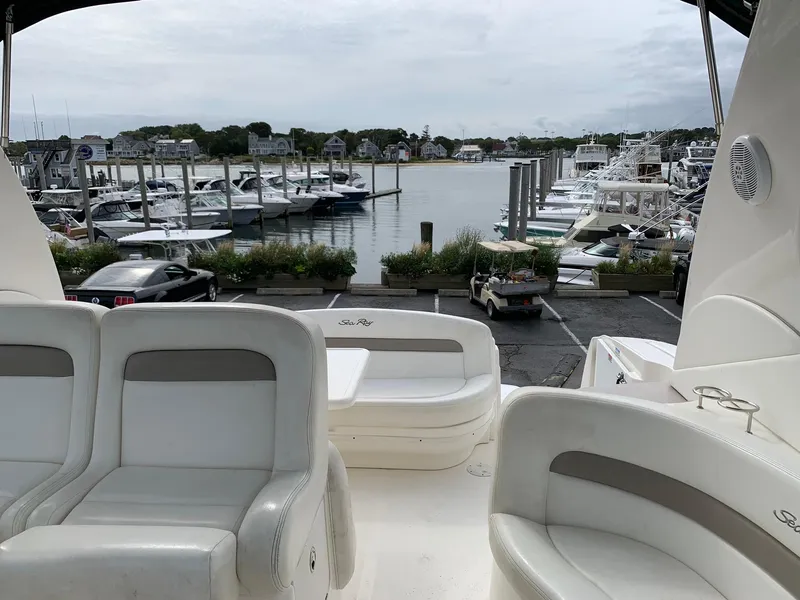 Slide: The Image of 2004 Sea Ray 320 Sundancer at marina with boats and waterfront view. - 10