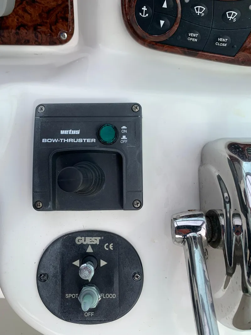 Slide: The Image of Control panel of a 2004 Sea Ray 320 Sundancer with bow thruster and light switches. - 19