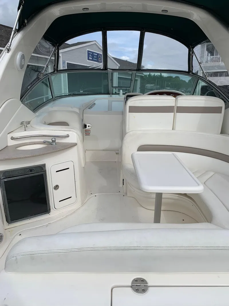 Slide: The Image of Interior of 2004 Sea Ray 320 Sundancer boat with seating and table. - 5