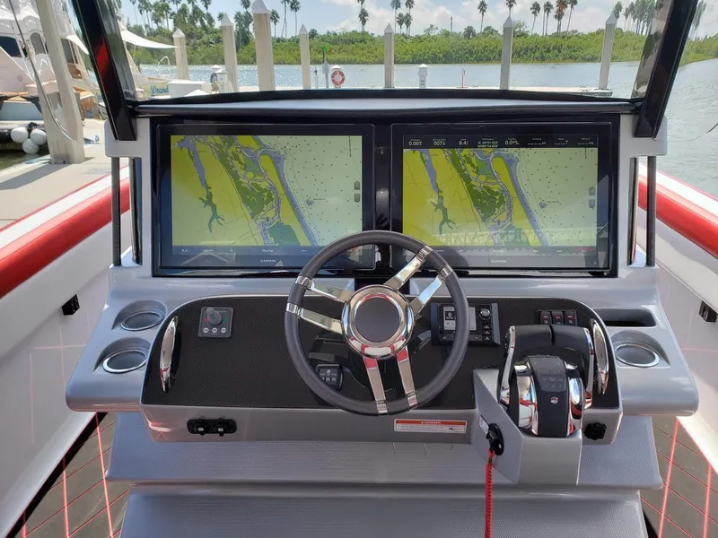 Slide: The Image of 2019 Mystic Powerboats M3800 helm with dual navigation screens and modern controls. - 10