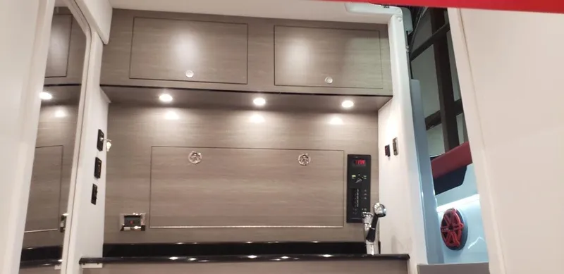 Slide: The Image of 2019 Mystic Powerboats M3800 interior with modern cabinetry and lighting. - 11