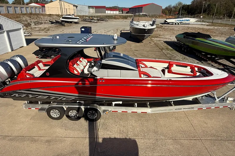 Slide: The Image of 2019 Mystic Powerboats M3800 in vibrant red on a trailer, parked outdoors. - 17