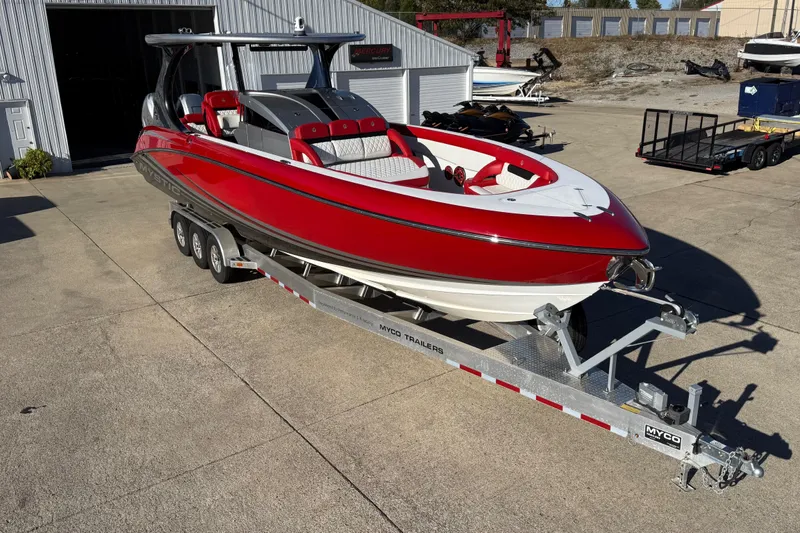 Slide: The Image of 2019 Mystic Powerboats M3800, red and white, on a trailer outside a warehouse. - 18