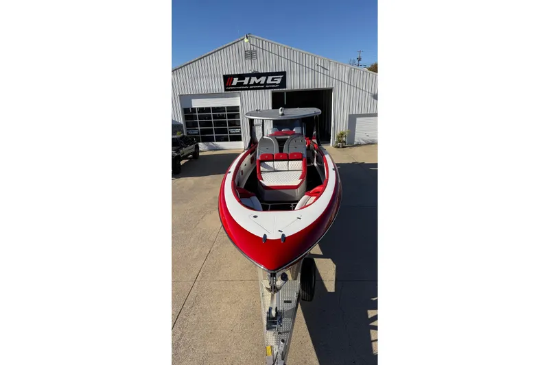 Slide: The Image of 2019 Mystic Powerboats M3800 in red and white, parked outside HMG building. - 25
