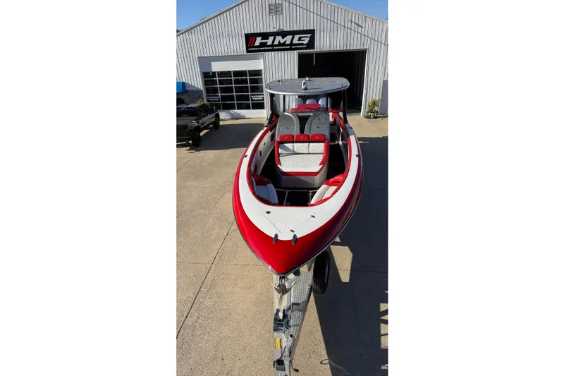 Slide: The Image of 2019 Mystic Powerboats M3800, red and white, parked outside HMG building. - 26
