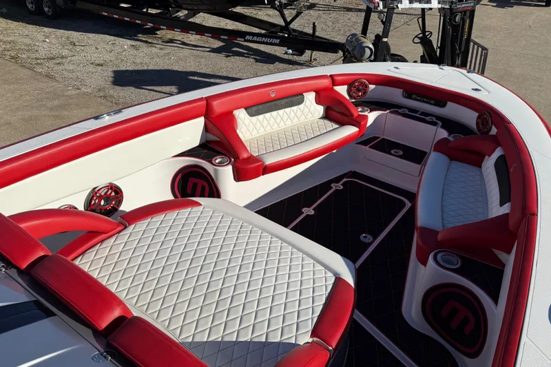 Slide: The Image of 2019 Mystic Powerboats M3800 interior with red and white seating, diamond stitching, and premium audio system. - 29