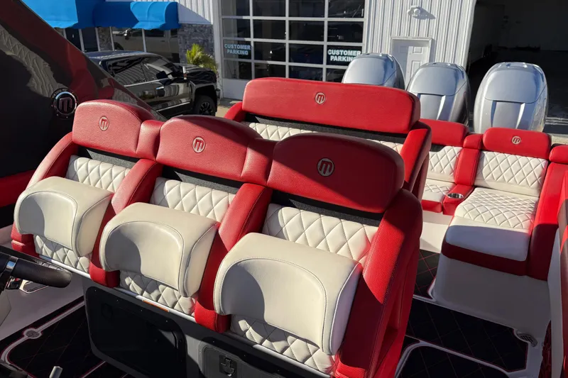 Slide: The Image of 2019 Mystic Powerboats M3800 interior with red and white quilted seats, showcasing luxury design. - 31
