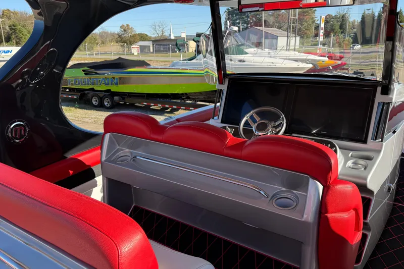 Slide: The Image of 2019 Mystic Powerboats M3800 interior with red seating and modern dashboard. - 33