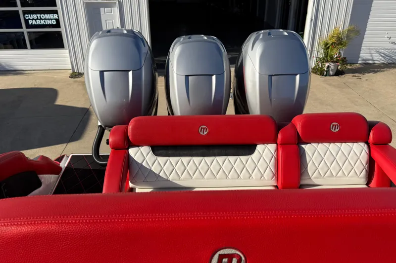 Slide: The Image of 2019 Mystic Powerboats M3800 with red and white seating, triple outboard engines. - 34