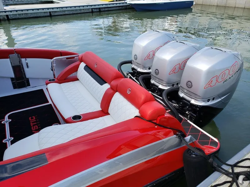 Slide: The Image of 2019 Mystic Powerboats M3800 with triple 400HP engines, red and white seating. - 4