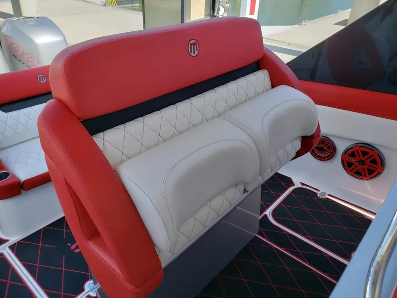 Slide: The Image of 2019 Mystic Powerboats M3800 interior with red and white seating, diamond stitching, and stylish design. - 5