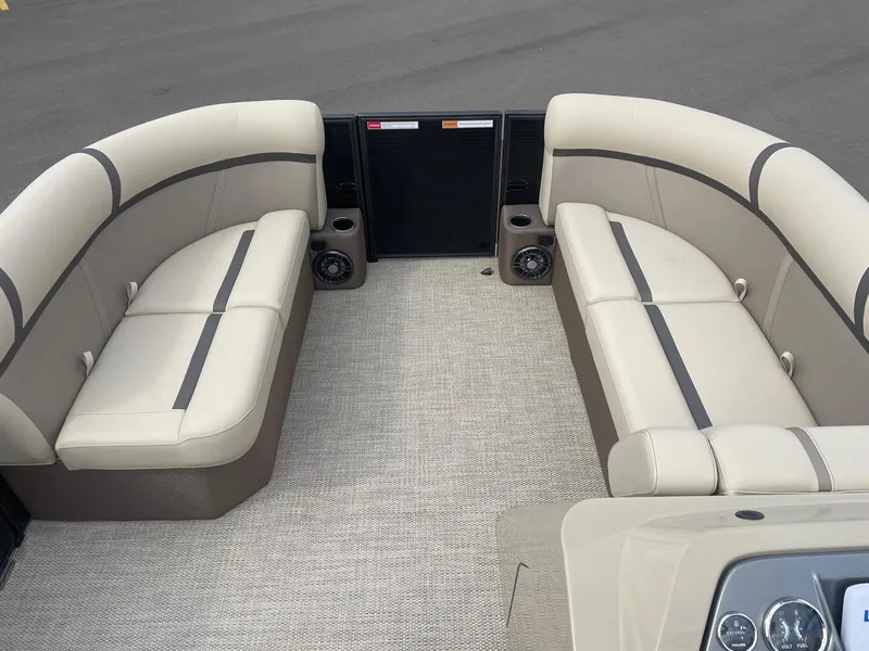 Slide: The Image of 2024 Crest 200SLC CLASSIC LX pontoon boat interior with beige seating and speakers. - 10