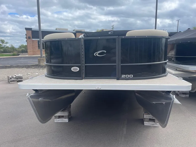 Slide: The Image of 2024 Crest 200SLC CLASSIC LX pontoon boat, front view, parked on a lot. - 2