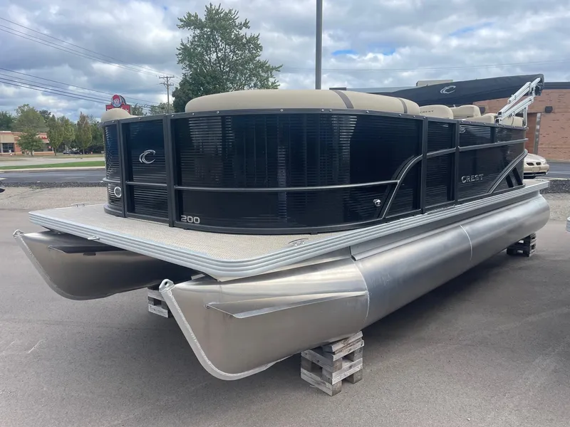 Slide: The Image of 2024 Crest 200SLC CLASSIC LX pontoon boat with sleek black design on display. - 3