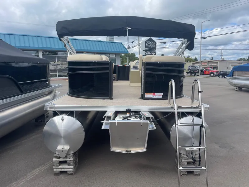 Slide: The Image of 2024 Crest 200SLC CLASSIC LX pontoon boat with canopy, docked in a marina. - 6