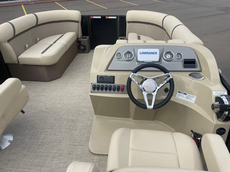 Slide: The Image of 2024 Crest 200SLC CLASSIC LX boat interior with beige seating and modern dashboard. - 8