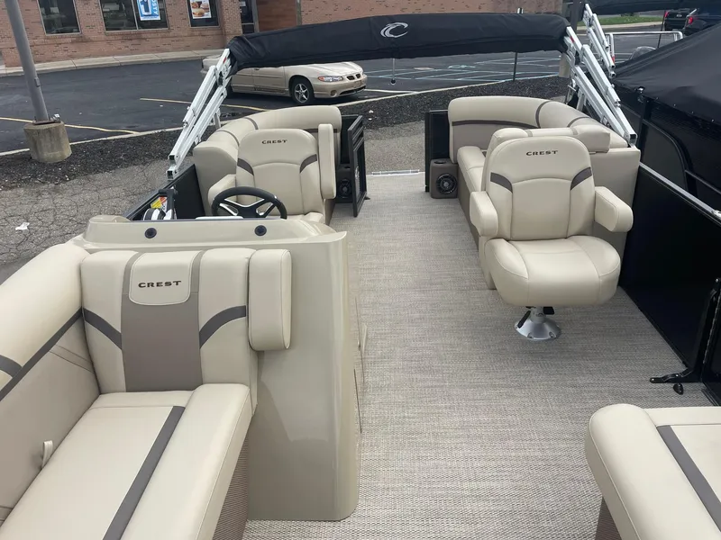 Slide: The Image of 2024 Crest 200SLC CLASSIC LX pontoon boat with beige seating and modern interior design. - 9