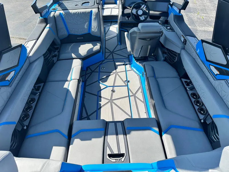Slide: The Image of 2025 Nautique G23 Paragon interior with blue accents and spacious seating. - 13
