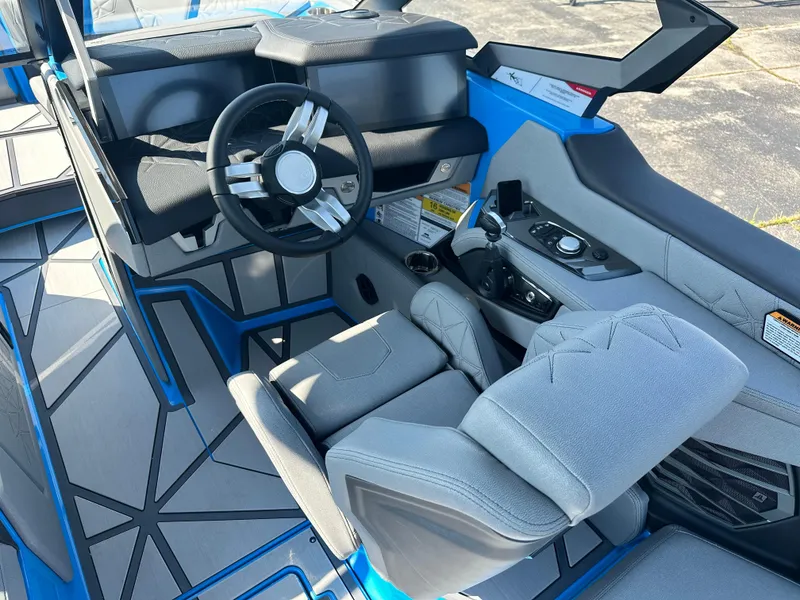 Slide: The Image of 2025 Nautique G23 Paragon boat interior with modern steering and seating design. - 14