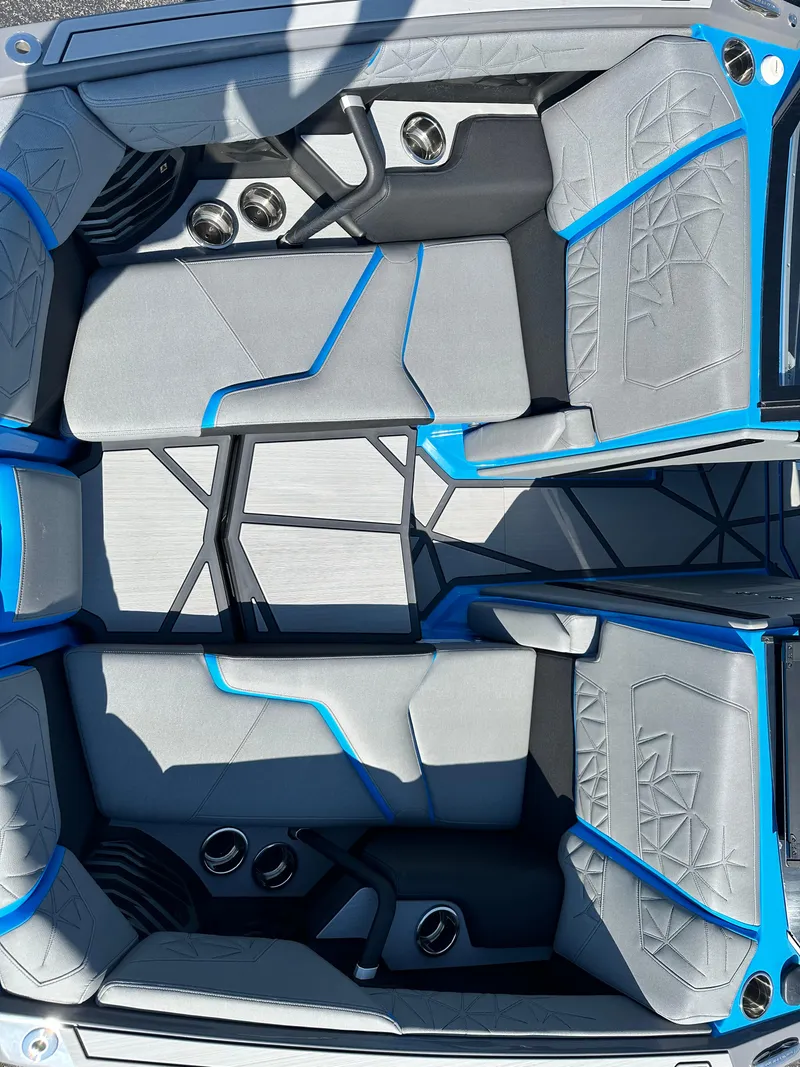 Slide: The Image of 2025 Nautique G23 Paragon interior with gray and blue seating, modern design. - 17