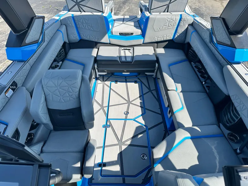 Slide: The Image of 2025 Nautique G23 Paragon interior with luxurious gray and blue seating arrangement. - 18
