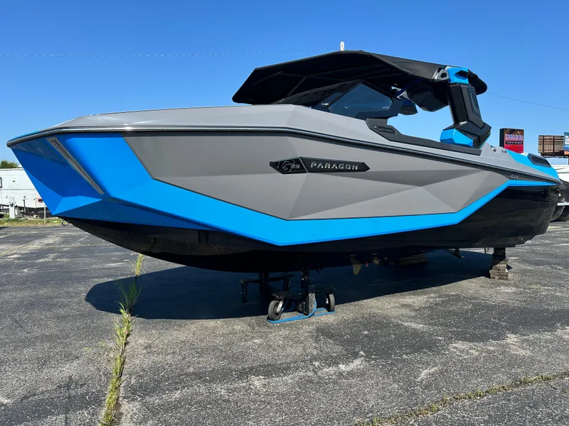 Slide: The Image of 2025 Nautique G23 Paragon boat with sleek gray and blue design on display. - 2