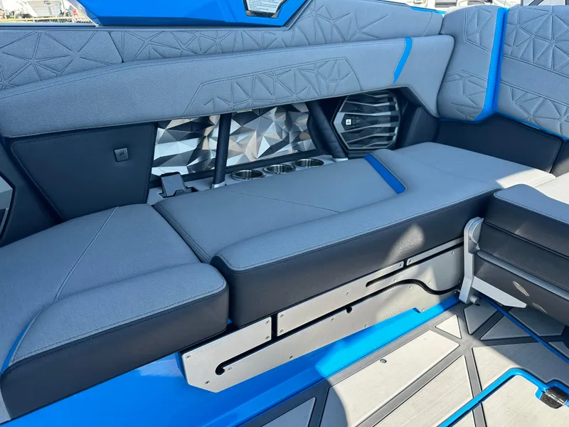 Slide: The Image of 2025 Nautique G23 Paragon interior with modern gray and blue seating design. - 21