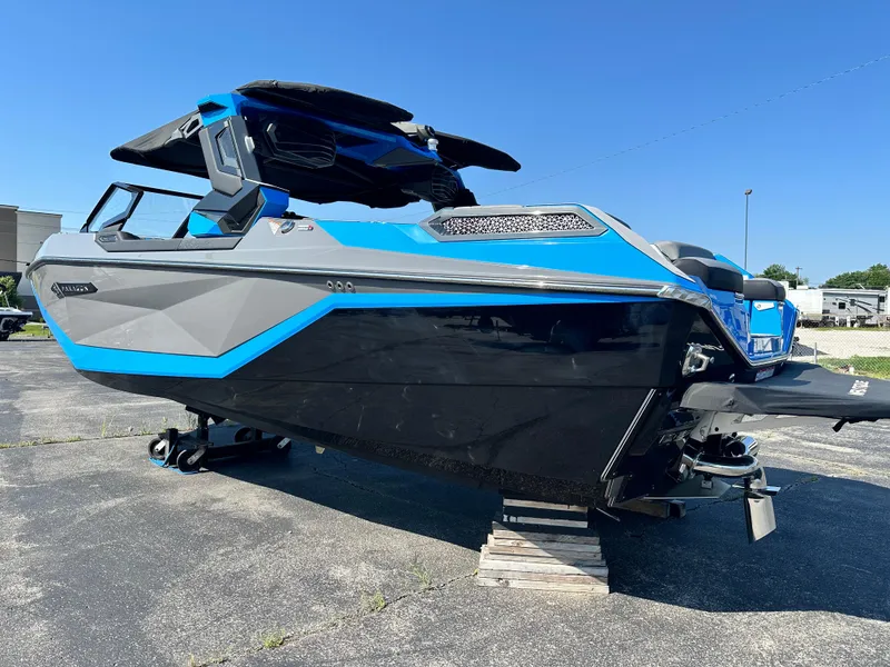 Slide: The Image of 2025 Nautique G23 Paragon boat with sleek blue and black design on display outdoors. - 3