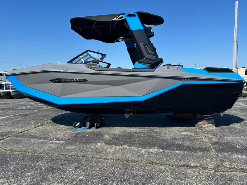 Slide: The Image of 2025 Nautique G23 Paragon boat with sleek gray and blue design on a concrete surface. - 7