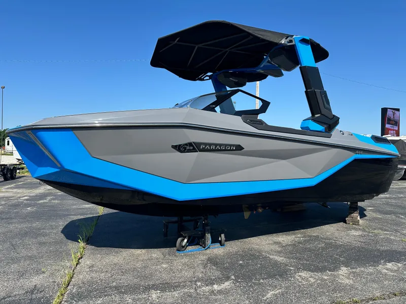 Slide: The Image of 2025 Nautique G23 Paragon boat with sleek gray and blue design on display. - 8