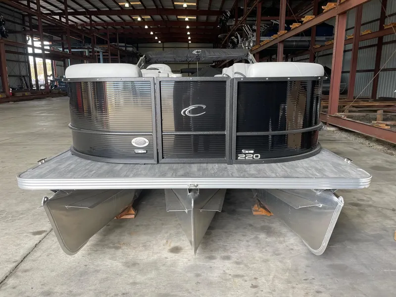 The Image of 2024 Crest 220 SLC Classic DLX pontoon boat in a warehouse setting. - 1