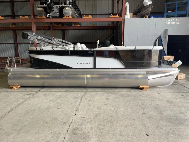 Slide: The Image of 2024 Crest 220 SLC Classic DLX pontoon boat in storage facility. - 2