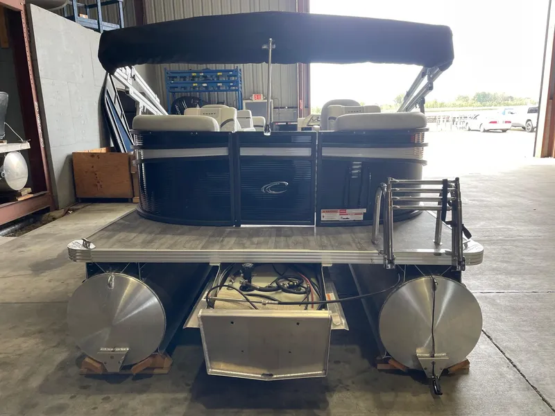 Slide: The Image of 2024 Crest 220 SLC Classic DLX pontoon boat in a warehouse setting. - 3