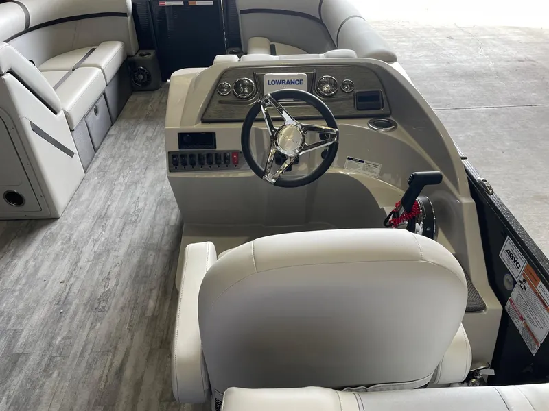 Slide: The Image of 2024 Crest 220 SLC Classic DLX boat interior with steering wheel and seating. - 6