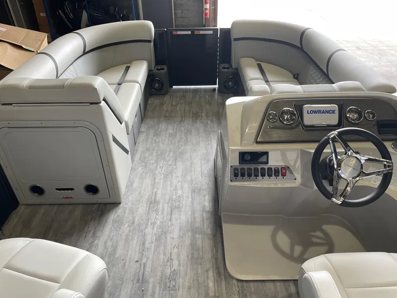 Slide: The Image of 2024 Crest 220 SLC Classic DLX boat interior with plush seating and modern dashboard. - 7