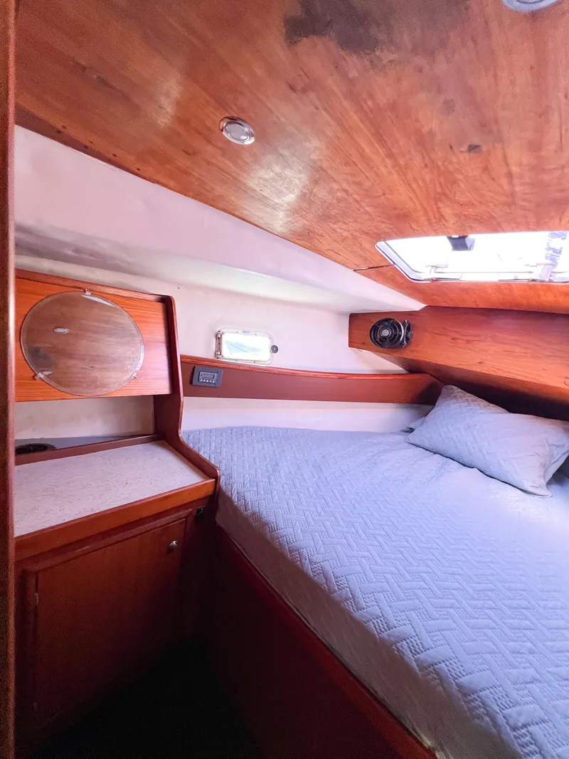Slide: The Image of Interior of a 1989 Jeanneau Voyage 11.20 yacht with cozy bed. - 13