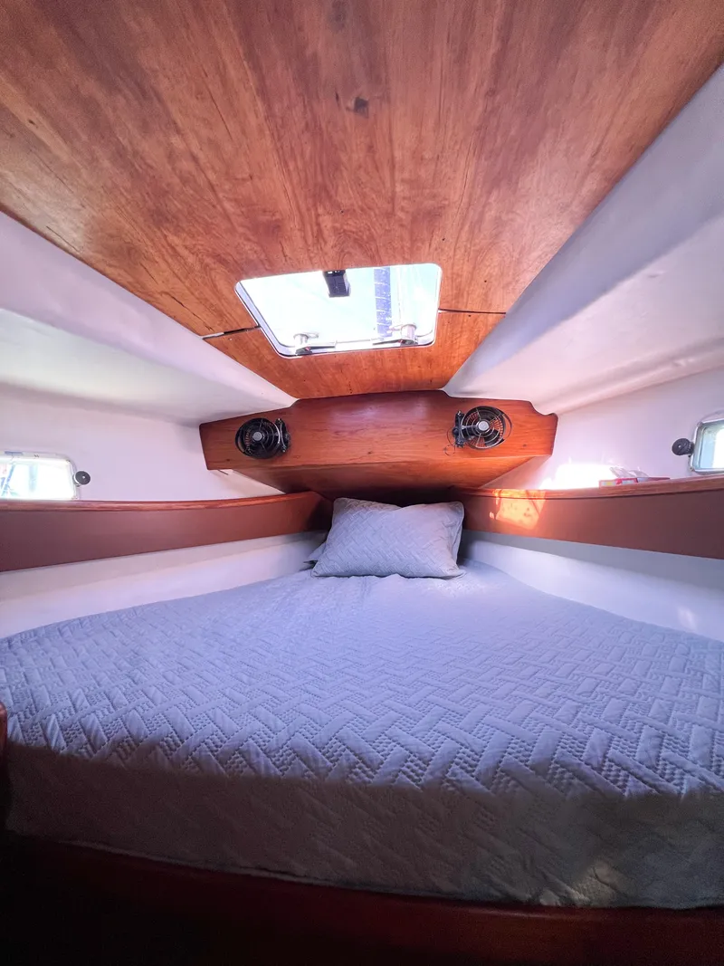Slide: The Image of Cabin of Jeanneau Voyage 11.20, 1989 model, featuring a cozy bed. - 14