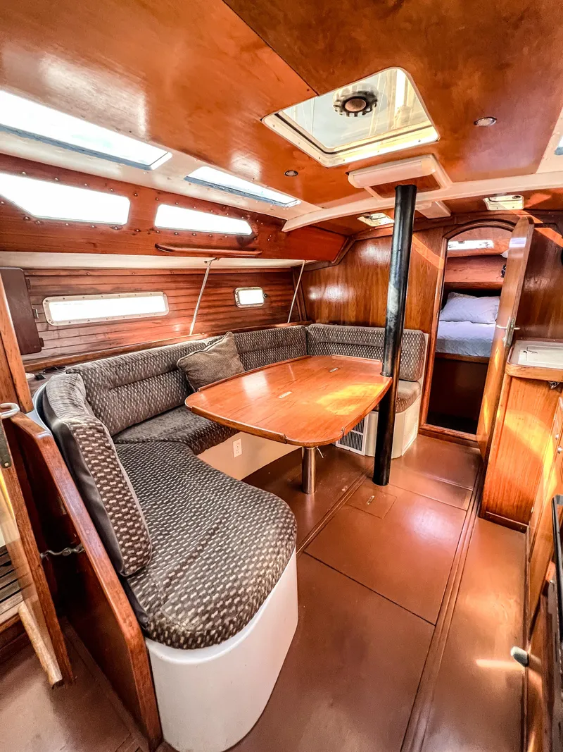 Slide: The Image of Interior of a 1989 Jeanneau Voyage 11.20 yacht with cozy seating area. - 19