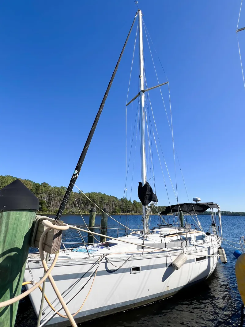 Slide: The Image of 1989 Jeanneau Voyage 11.20 sailboat docked under clear sky. - 2